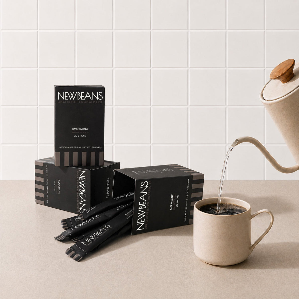 Newbeans Americano box on a kitchen counter beside a freshly poured cup of black coffee