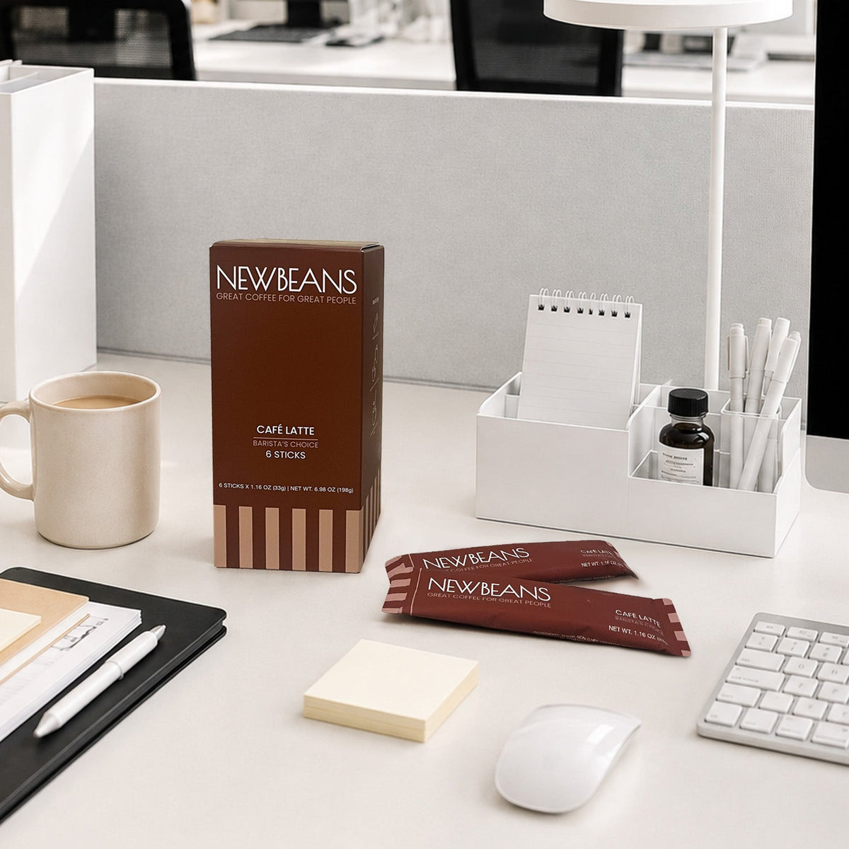 Newbeans Café Latte box and sticks on an office desk beside a mug