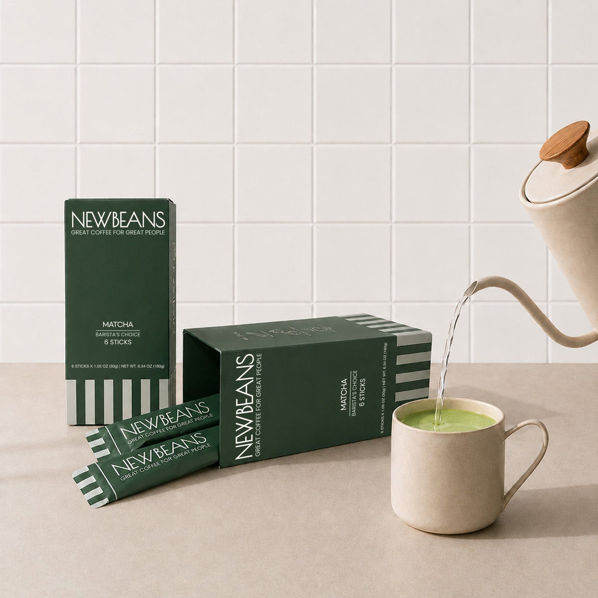 Newbeans Matcha box on a kitchen counter beside a freshly poured matcha latte